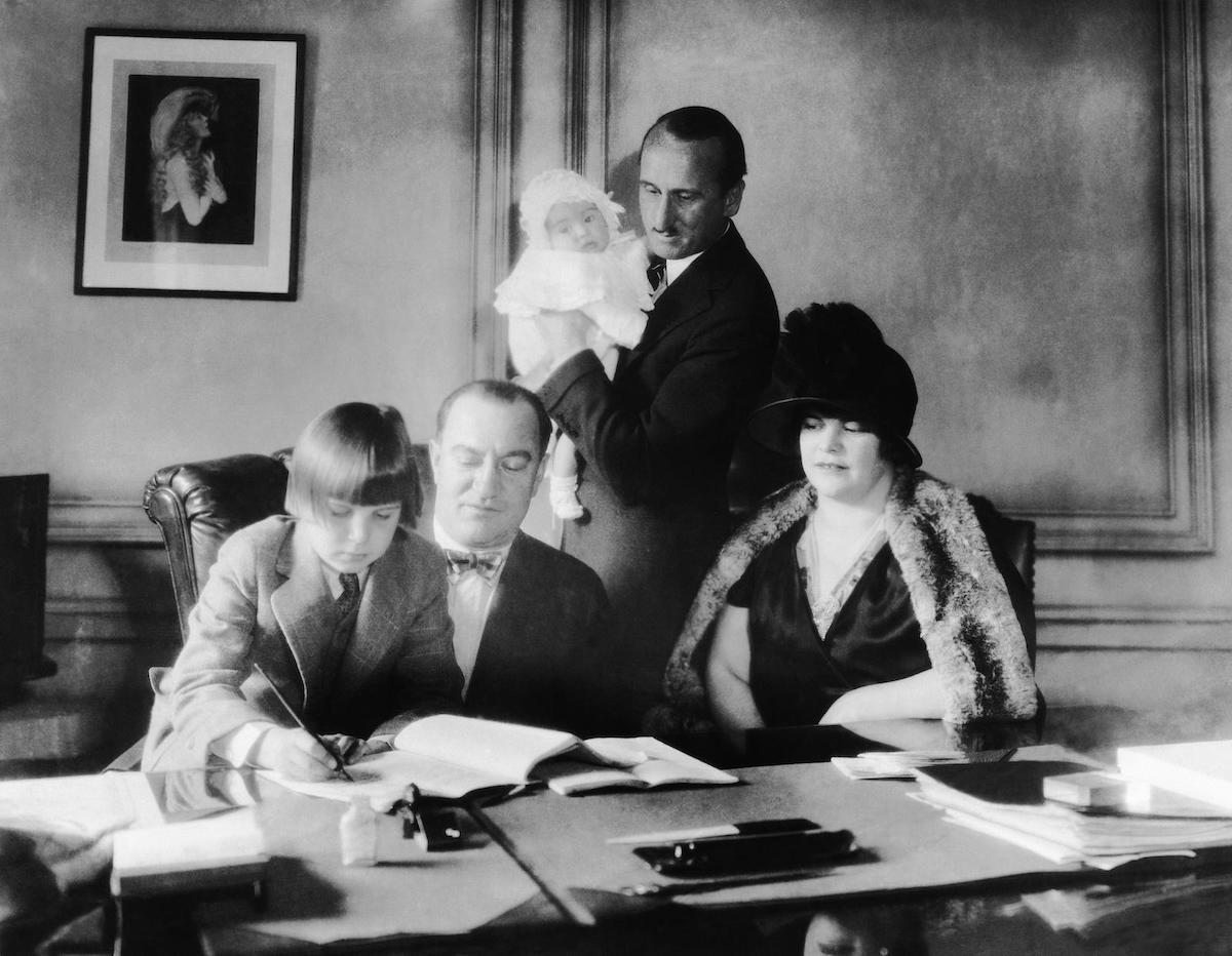 Jackie Coogan signing a contract with MGM vice president Nicholas Schenck, with his parents looking on, 1925. Evertt Collection Inc/Alamy Stock Photo. Jackie Coogan signing a contract with MGM vice president Nicholas Schenck, with his parents looking on, 1925. Evertt Collection Inc/Alamy Stock Photo.